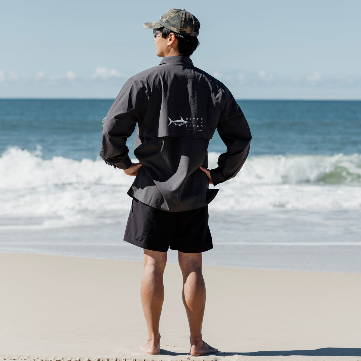 Man on beach wearing Coal Fishing Adventure Shirt Back