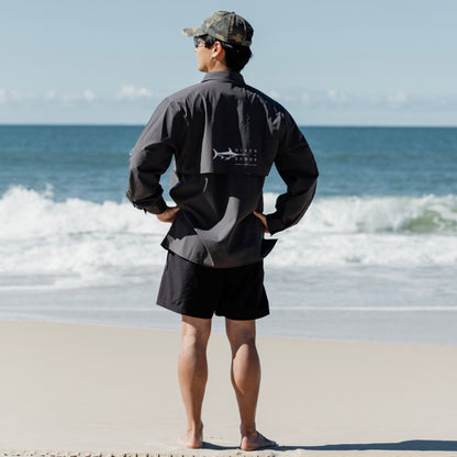 Man on beach wearing Coal Fishing Adventure Shirt Back