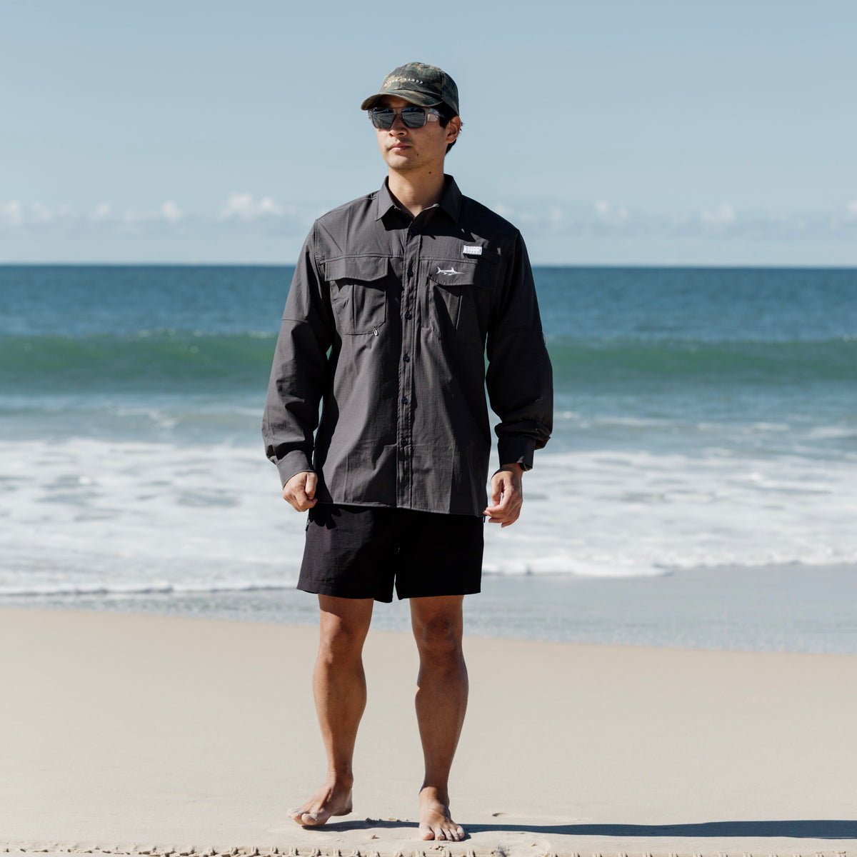 Man on beach wearing Coal Fishing Adventure Shirt