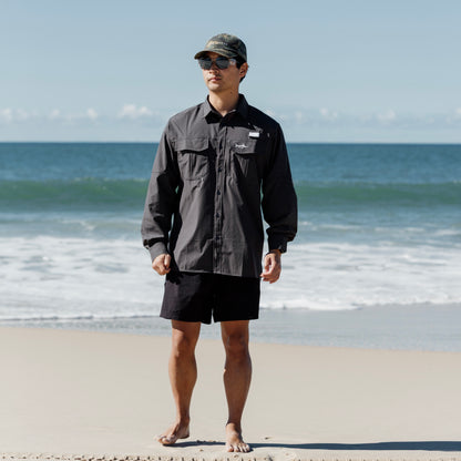 Man on beach wearing Coal Fishing Adventure Shirt