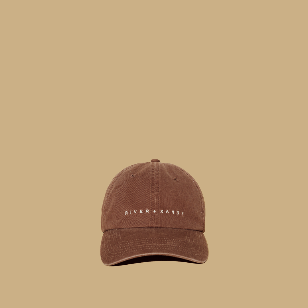 Tan River and Sands Dad cap product shot front on.