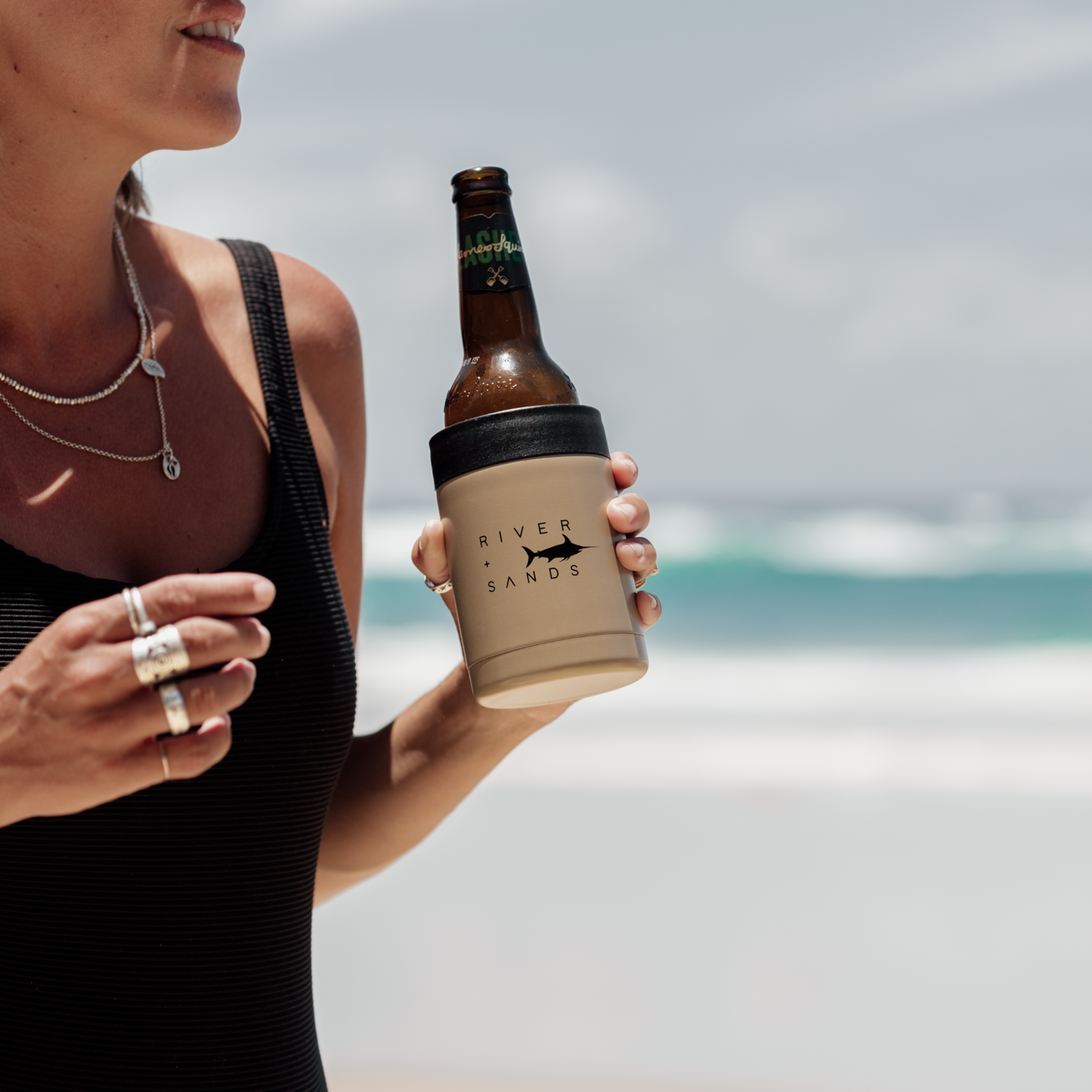 Woman holding for her tan river and sands can cooler.