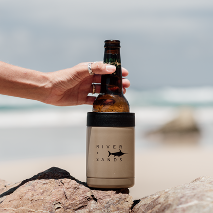 Woman reaching for her tan river and sands can cooler.