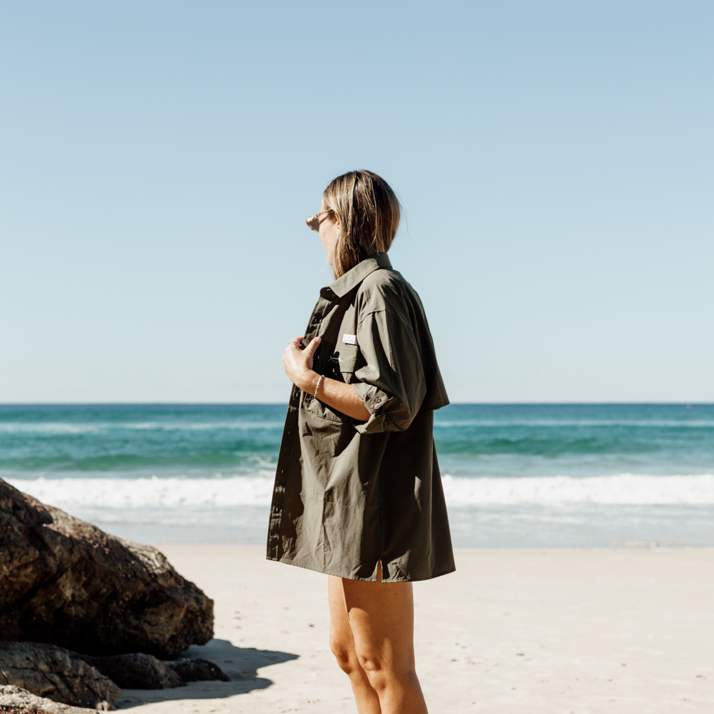 Woman wearing fishing shirt at the beach and looking good.