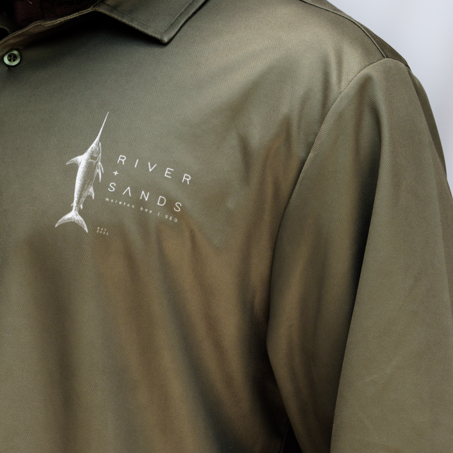 Close up of the sands fishing shirt of the logo.