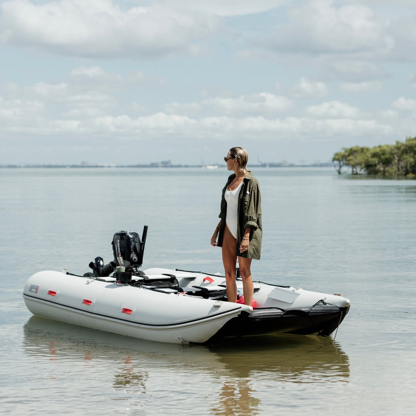 A woman on a boat wearing the Khaki River Adventure Shirt outdoors – lightweight, quick-dry performance gear designed in Brisbane.