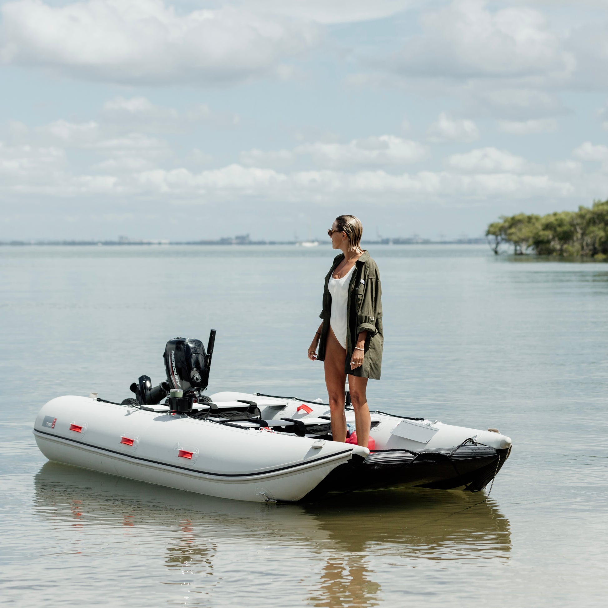 A woman on a boat wearing the Khaki River Adventure Shirt outdoors – lightweight, quick-dry performance gear designed in Brisbane.